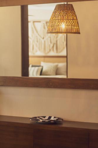a lamp on top of a dresser with a mirror at Stylish 2BR Apt Private Pool, Terrace, Fast WiFi Tulum A102 in Tulum