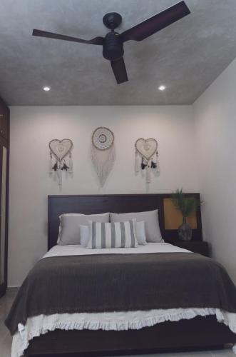 a bedroom with a bed and a ceiling fan at Stylish 2BR Apt Private Pool, Terrace, Fast WiFi Tulum A102 in Tulum