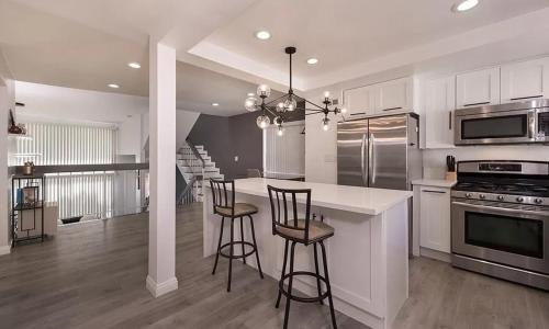 a kitchen with a counter and two bar stools at Private room in beautiful modern Calabasas townhouse in Calabasas