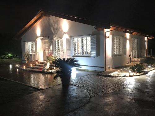 a house with a palm tree in front of it at night at La Tenuta Michele in Naples