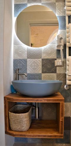 a bathroom with a sink and a mirror at TRULLI MATRICE in Alberobello