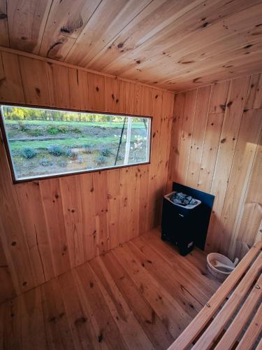 an inside view of a wooden cabin with a window at Le Domaine de Bra in Bra