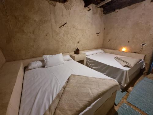 two twin beds in a room with at ECO ROOMS Siwa in Siwa