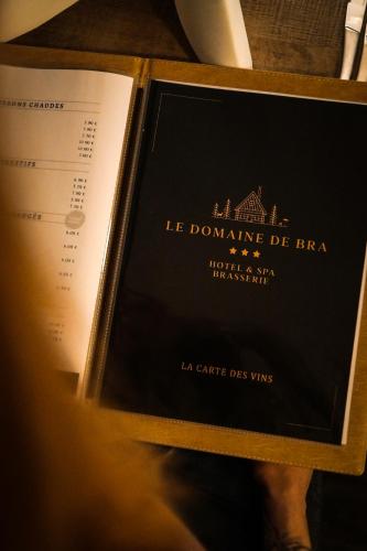 a bottle of wine in a box with a book at Le Domaine de Bra in Bra