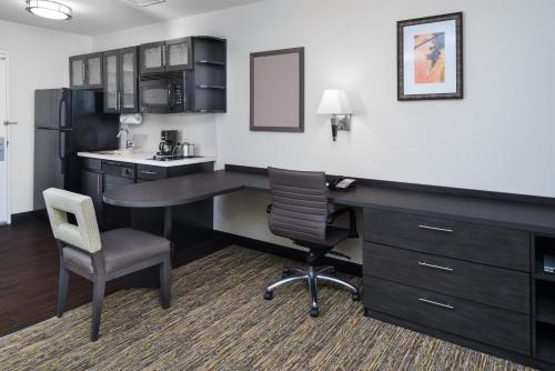 an office with a desk and a chair and a computer at Candlewood Suites Olympia - Lacey by IHG in Lacey