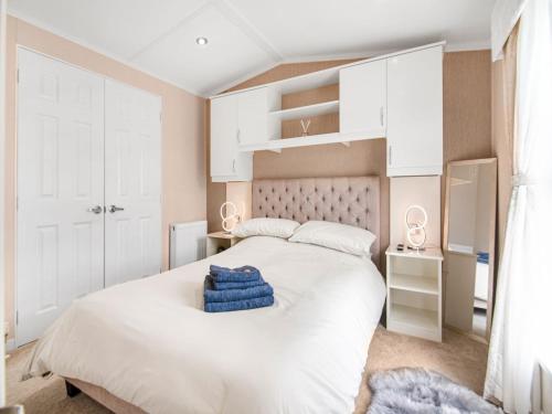 1 dormitorio con 1 cama grande y armarios blancos en European Lodge - Uk40848 en Scarborough