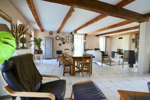 a living room with a table and chairs at Maison de Margot in Peyriac-Minervois