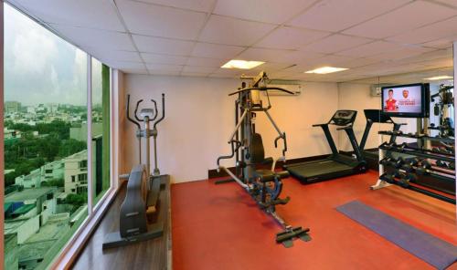 a gym with two tread machines and a window at Quality Inn Gurgaon in Gurgaon