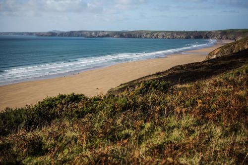 a view of a beach with the ocean at Swn Y Don in Haverfordwest