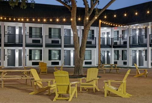a group of chairs and tables in front of a building at Atrea Inn Amarillo in Amarillo
