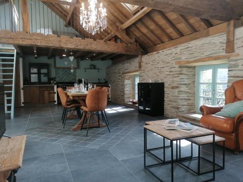a living room with a couch and a table at La Maison de Madeleine in Léglise