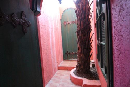 a bathroom with a tree in the middle of a hallway at A Fei Surf Inn III in Nanwan