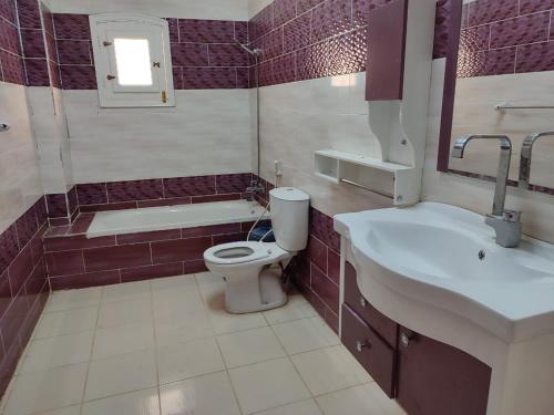 a bathroom with a toilet and a sink at Best appartment in Quseir