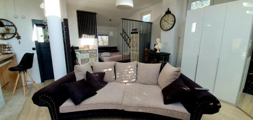a couch with pillows on it in a living room at ANTICA in Vrh nad Želimljami
