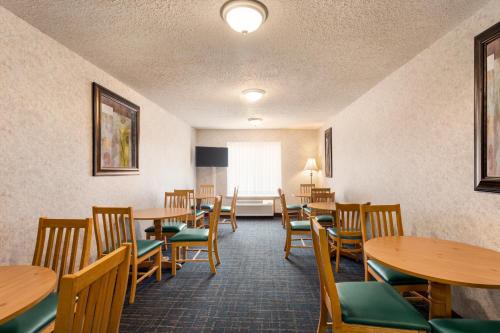 a dining room with wooden tables and chairs at Days Inn by Wyndham Hurley in Hurley