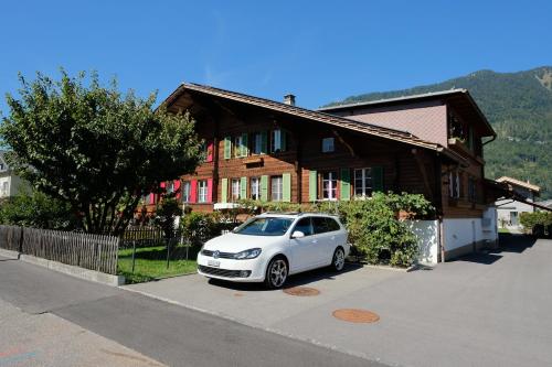 a white car parked in front of a house at CLOUD No3, Interlaken in Matten