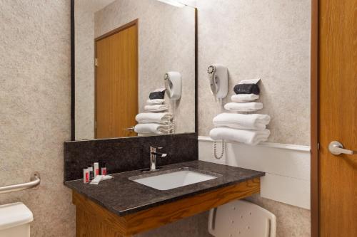 a bathroom with a sink and a mirror at Days Inn by Wyndham Hurley in Hurley
