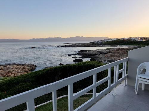 a balcony with a view of the ocean at On the Rocks Guesthouse in Gansbaai