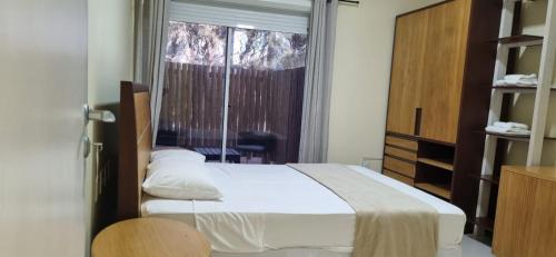 a bedroom with a bed and a large window at ALIZE CUMBUCO in Cumbuco
