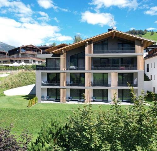a large building with a lot of windows at Residence Le Fostü in San Vigilio Di Marebbe