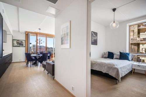 a bedroom with a bed and a dining room at Amazing luxury apartment on the waterfront! 73sqm in Oslo