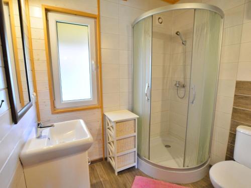 a bathroom with a shower and a sink and a toilet at Holiday home in Ustronie Morskie with a playground in Ustronie Morskie