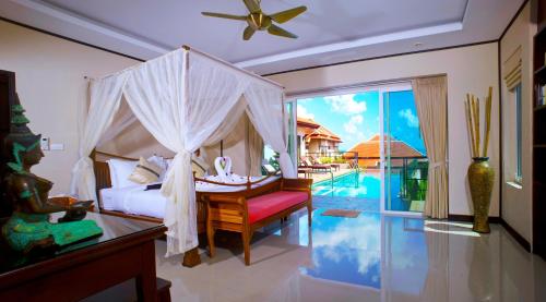 a bedroom with a canopy bed and a pool at Samui Sunrise Seaview Villa in Chaweng