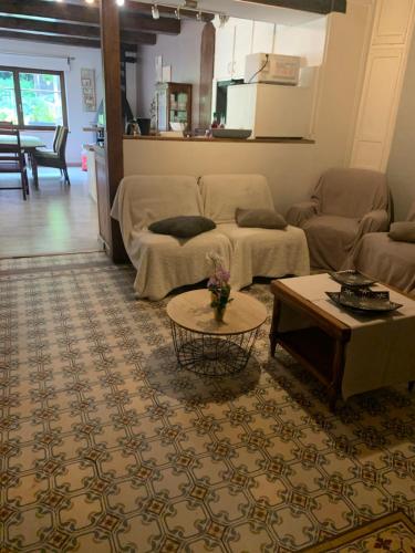 a living room with a couch and a table at Le gîte du chateau dans le centre de schirmeck in Schirmeck