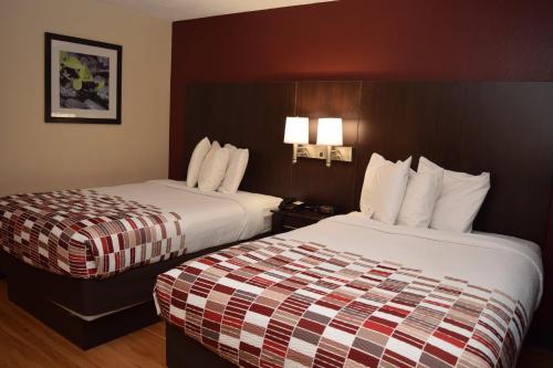 um quarto de hotel com duas camas e duas lâmpadas em Red Roof Inn Batavia em Batavia