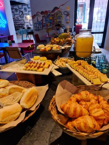 a buffet with many different types of bread and pastries at JO&JOE Rio de Janeiro Largo do Boticario in Rio de Janeiro