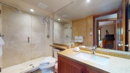 a bathroom with a sink and a shower and a toilet at Golf Course & Mountain Views by Harmony Whistler in Whistler