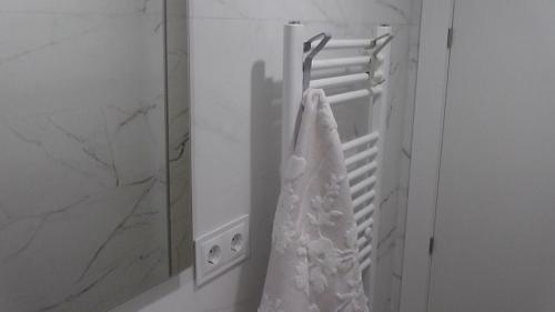 a wedding dress hanging on a rack in front of a mirror at Piso céntrico León 2 in León