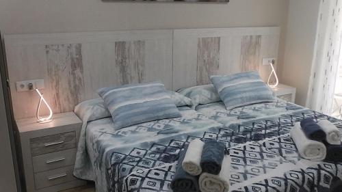 a bedroom with a bed with blue and white sheets and pillows at Piso céntrico León 2 in León