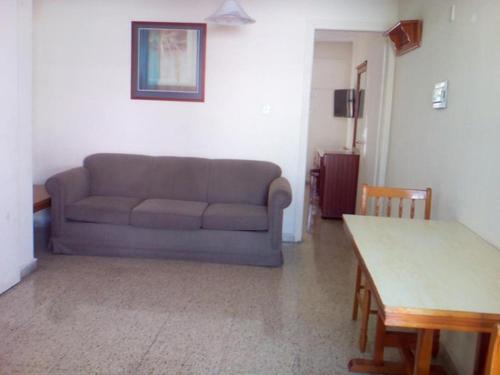a living room with a couch and a table at Flora Maria Hotel in Ayia Napa