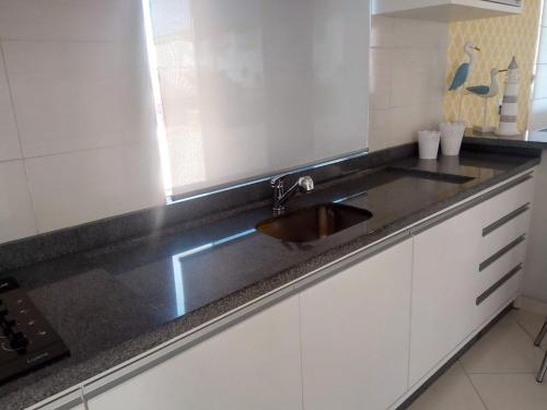 a kitchen with a sink and a counter top at Casa Premium em Balneário Gaivota in Sombrio