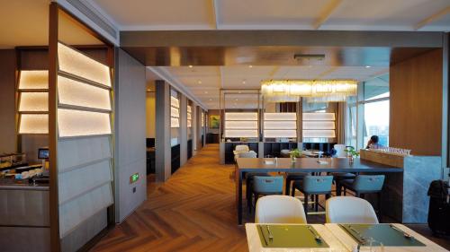 a restaurant with a table and chairs and a dining room at The Azure Ningbo, Vignette Collection in Ningbo