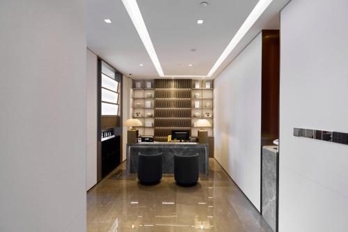 a hotel lobby with a bar and a wine cellar at The Azure Ningbo, Vignette Collection in Ningbo