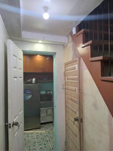 a small kitchen with a sink and a refrigerator at Balili Property at Metro Manila Hills Subd Rodriguez Rizal in Manila