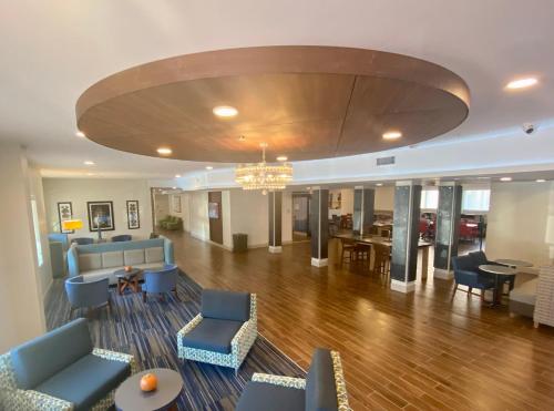 a living room with blue furniture and a dining room at Holiday Inn Express & Suites - Dahlonega - University Area by IHG in Dahlonega