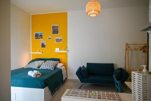a bedroom with a blue bed and a chair at Casa Vacanza Le Dune- Sole in Maruggio