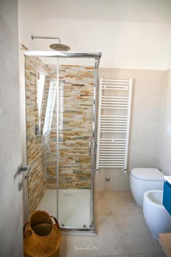 a bathroom with a shower and a toilet at Casa Vacanza Le Dune- Sole in Maruggio