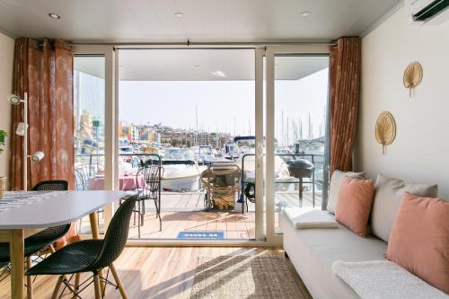 a living room with a couch and a table at The Homeboat Company Albufeira in Albufeira