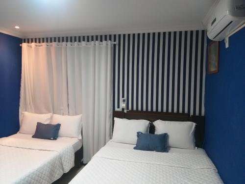 two beds sitting next to each other in a bedroom at Casa 1 Encanto dos Mares in Itapema