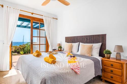 a bedroom with a bed with a view of the ocean at Oceanfront Holiday with Stunning Views in San Miguel de Abona