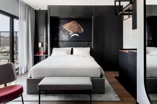 a bedroom with a bed with a black wall at Radisson RED Madrid in Madrid