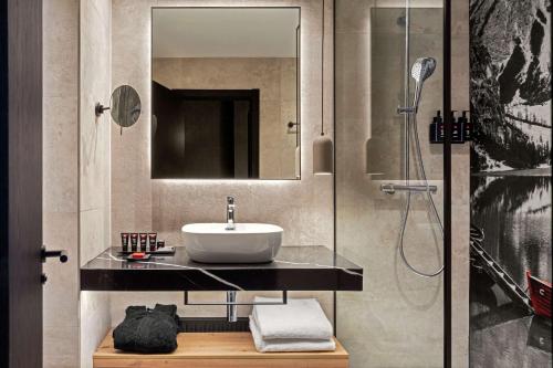 a bathroom with a sink and a shower at Radisson RED Madrid in Madrid