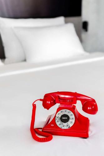 a red phone sitting on top of a table at Radisson RED Madrid in Madrid