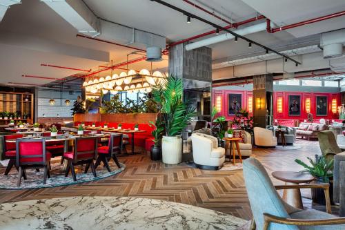 a restaurant with tables and chairs in a room at Radisson RED Madrid in Madrid