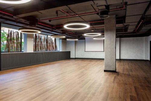 an empty room with a wooden floor and lights at Radisson RED Madrid in Madrid