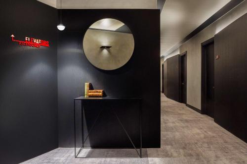 a hallway with a mirror on the wall and a table at Radisson RED Madrid in Madrid